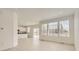 Bright and airy living room with light wood floors, large windows, and access to the backyard at 16686 E 110Th Ave, Commerce City, CO 80022