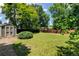 A well-maintained lawn and a storage shed are surrounded by a wood fence and mature trees for privacy and function at 6775 Coors Ct, Arvada, CO 80004