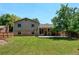 Expansive backyard with a covered patio, well-maintained lawn, and mature tree, creating a serene outdoor space at 6775 Coors Ct, Arvada, CO 80004