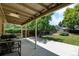 Exterior view of covered backyard patio, lush lawn, shed, and privacy fence at 6775 Coors Ct, Arvada, CO 80004