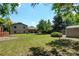 A lush backyard with a patio, storage shed and large trees perfect for shade during the warm summer months at 6775 Coors Ct, Arvada, CO 80004