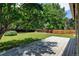 Well-maintained backyard featuring a spacious deck, lush lawn, mature trees, and a privacy fence at 6775 Coors Ct, Arvada, CO 80004