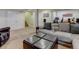 Basement living room with large sectional sofa, stairs leading to the upper floors, and two closets at 6775 Coors Ct, Arvada, CO 80004