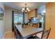 Dining room with hardwood floors, wood table, and natural light at 6775 Coors Ct, Arvada, CO 80004
