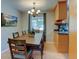 Dining room with hardwood floors, wood table, and natural light at 6775 Coors Ct, Arvada, CO 80004