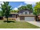 Charming two-story home with a well-maintained lawn and mature trees on a sunny day at 6775 Coors Ct, Arvada, CO 80004