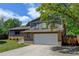 Charming two-story home with a well-maintained lawn and mature trees on a sunny day at 6775 Coors Ct, Arvada, CO 80004