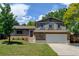 Charming two-story home with a well-maintained lawn and mature trees on a sunny day at 6775 Coors Ct, Arvada, CO 80004