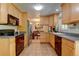 Bright kitchen with light wood cabinets and tile floors open to dining area at 6775 Coors Ct, Arvada, CO 80004