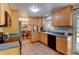 Well-lit kitchen with light wood cabinets and tiled floors, adjacent to the dining room at 6775 Coors Ct, Arvada, CO 80004