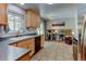 Bright kitchen with natural wood cabinets and view into an office/den at 6775 Coors Ct, Arvada, CO 80004
