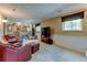 Spacious living room area featuring comfortable leather seating and a wall-mounted TV at 6775 Coors Ct, Arvada, CO 80004