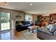 Comfortable living room featuring plush leather furniture and hardwood floors at 6775 Coors Ct, Arvada, CO 80004