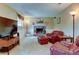 Relaxing living room area featuring a brick fireplace and comfortable leather seating at 6775 Coors Ct, Arvada, CO 80004