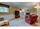 Cozy living room area featuring a brick fireplace and comfortable leather seating at 6775 Coors Ct, Arvada, CO 80004