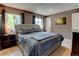 Comfortable main bedroom with large window, night stands, and a gray upholstered headboard at 6775 Coors Ct, Arvada, CO 80004