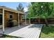 Covered patio with outdoor seating and grill, offering a cozy space for entertaining and relaxing in the backyard at 6775 Coors Ct, Arvada, CO 80004