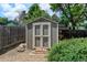 Backyard shed with double doors for convenient storage and access with decorative stone steps leading up to it at 6775 Coors Ct, Arvada, CO 80004