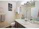 Bright bathroom features a stylish vanity, framed mirror, and shower-tub combo at 2895 W Riverwalk Cir # 104, Littleton, CO 80123
