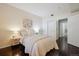 Comfortable bedroom features a queen bed, wood-style floors, and sliding-door closet at 2895 W Riverwalk Cir # 104, Littleton, CO 80123