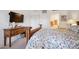 Bright bedroom featuring a wooden bed frame, a flat screen television, and an ensuite bathroom at 2895 W Riverwalk Cir # 104, Littleton, CO 80123