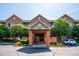 Inviting brick building entrance with well-maintained landscaping and convenient parking at 2895 W Riverwalk Cir # 104, Littleton, CO 80123