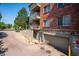 Exterior elevation showing balconies and garage access at 2895 W Riverwalk Cir # 104, Littleton, CO 80123