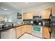 Close up of the kitchen featuring stainless steel appliances, modern cabinets, and granite countertops at 2895 W Riverwalk Cir # 104, Littleton, CO 80123