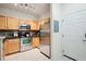 Efficient kitchen featuring stainless steel appliances, light wood cabinets, and a tiled backsplash at 2895 W Riverwalk Cir # 104, Littleton, CO 80123
