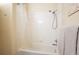 Shower-tub combo with white subway tile, shower curtain, and shower head at 2895 W Riverwalk Cir # 104, Littleton, CO 80123