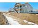 Rear elevation with walkout basement and deck, showcasing the expansive backyard at 13690 Emerald Lake St, Parker, CO 80138