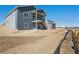 Rear elevation of house with walkout basement and two-story deck with stairs at 13690 Emerald Lake St, Parker, CO 80138