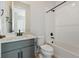 Bright bathroom featuring modern fixtures, blue vanity and shower/tub combo at 13690 Emerald Lake St, Parker, CO 80138