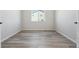 Empty room featuring wood floors, white walls, baseboards and a window with a view to the outside at 13690 Emerald Lake St, Parker, CO 80138