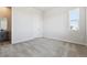 A serene bedroom with neutral walls, a large window, and plush carpeting at 13690 Emerald Lake St, Parker, CO 80138