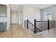 Bright hallway featuring hardwood floors, a staircase, and a view of the front door at 13690 Emerald Lake St, Parker, CO 80138