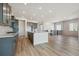 The kitchen and living room share an open floor plan, gray cabinets, and a large island at 13690 Emerald Lake St, Parker, CO 80138