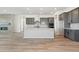 Modern kitchen featuring an island, stainless steel appliances, light countertops, and hardwood floors at 13690 Emerald Lake St, Parker, CO 80138