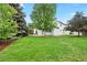 Lush backyard with green grass, mature trees, and a patio perfect for outdoor relaxation and entertainment at 9756 Quay Loop, Broomfield, CO 80021