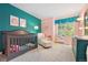 A serene Bedroom with a modern crib, comfy armchair, and stylish decor for a calming environment at 9756 Quay Loop, Broomfield, CO 80021
