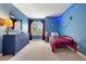 Nautical-themed bedroom with blue walls, red accents, and playful decorative lighting for a fun atmosphere at 9756 Quay Loop, Broomfield, CO 80021