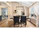 Bright dining room with a rustic table and modern lighting fixture at 9756 Quay Loop, Broomfield, CO 80021