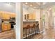 Open kitchen with wooden cabinets, stainless steel appliances, and breakfast bar at 9756 Quay Loop, Broomfield, CO 80021