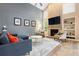 Spacious living room featuring a cozy fireplace and comfortable seating at 9756 Quay Loop, Broomfield, CO 80021