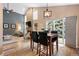 Living and dining area offers a beautiful brick fireplace, tall ceilings, and a sliding glass door to the backyard at 9756 Quay Loop, Broomfield, CO 80021