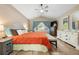Cozy main bedroom with a large bed, vaulted ceilings, a ceiling fan, and a large bright window at 9756 Quay Loop, Broomfield, CO 80021
