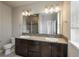 Modern bathroom with double vanity, granite counters, and a glass-enclosed shower at 630 E Hinsdale Ave, Littleton, CO 80122
