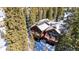 Stunning aerial shot showcasing the mountain home nestled in the forest at 960 Whispering Pines Ln, Breckenridge, CO 80424