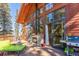 Spacious back deck with a stone fireplace, outdoor seating and views at 960 Whispering Pines Ln, Breckenridge, CO 80424