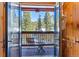 A charming balcony with seating offers a stunning view of snow-covered mountains at 960 Whispering Pines Ln, Breckenridge, CO 80424